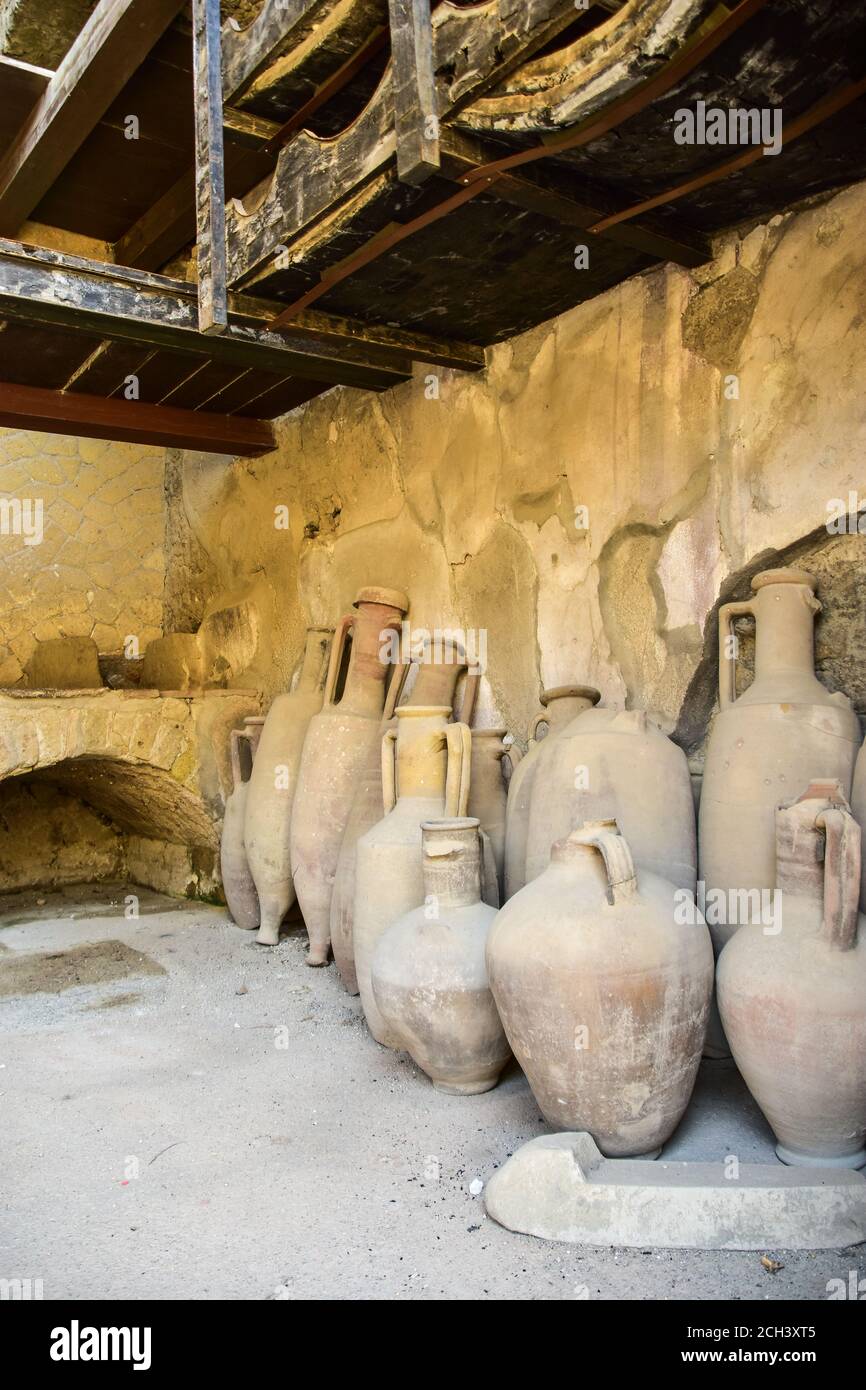 Vasi di argilla (anfore) in un negozio di alimentari (bottega) a Ercolano, una città romana, distrutta dall'eruzione del Vesuvio nel 79 d.C. Foto Stock