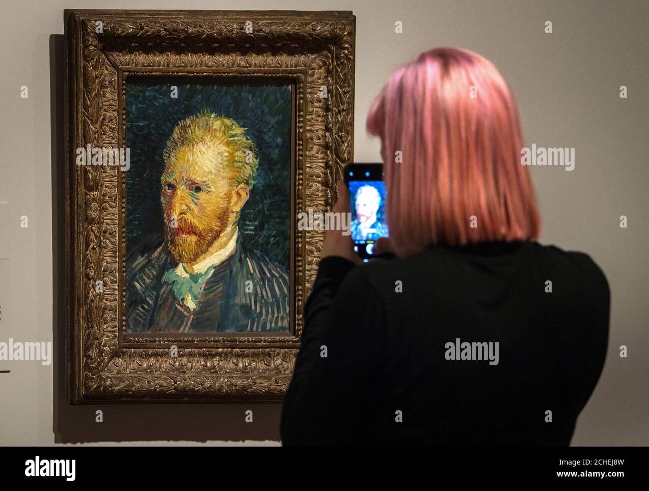 Un visitatore scatta una fotografia di 'Self Portrait' (1887) di Vincent van Gogh durante l'anteprima per l'EY Exhibition: Van Gogh e Gran Bretagna a Tate Britain, Londra, che prende un nuovo sguardo all'artista attraverso il suo rapporto con la Gran Bretagna. Foto Stock