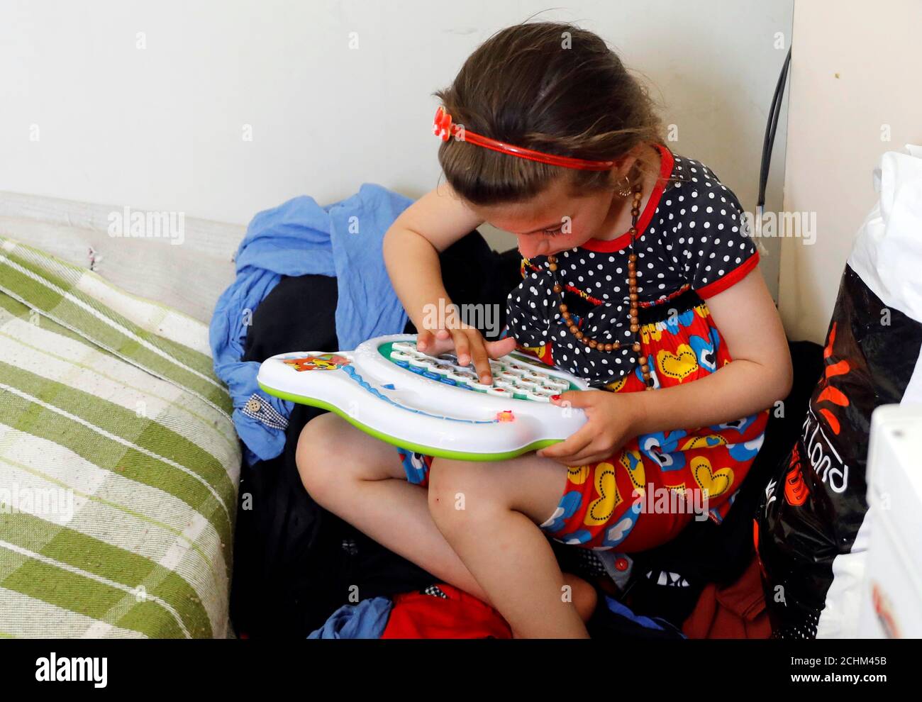 L'iracheno Christina Ezzo Abada, ex ostaggio di militanti dello Stato islamico per tre anni, gioca all'interno di una casa ristretta in un campo profughi di Erbil, Iraq, 10 giugno 2017. REUTERS/Erik De Castro Foto Stock