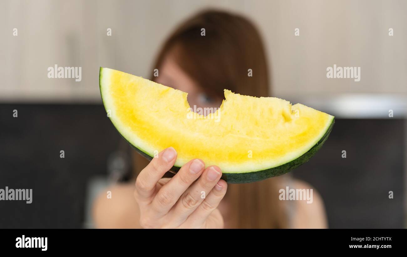 Fetta di anguria gialla con morso Foto Stock