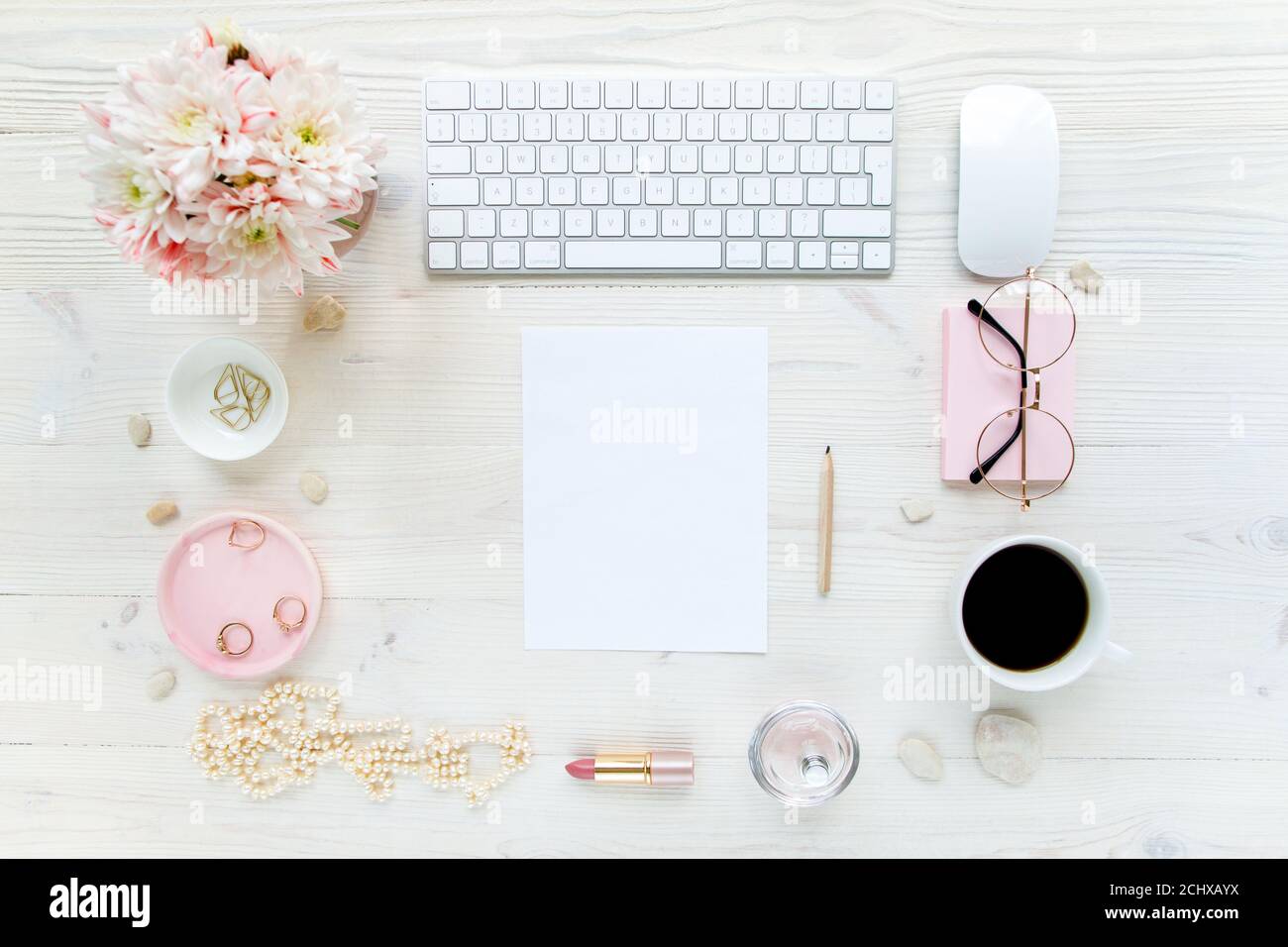Spazio di lavoro con, computer, carta bianca, crisantemo. Accessori moda donna su sfondo bianco di legno. Riviste, media. Disposizione piatta, vista dall'alto Foto Stock