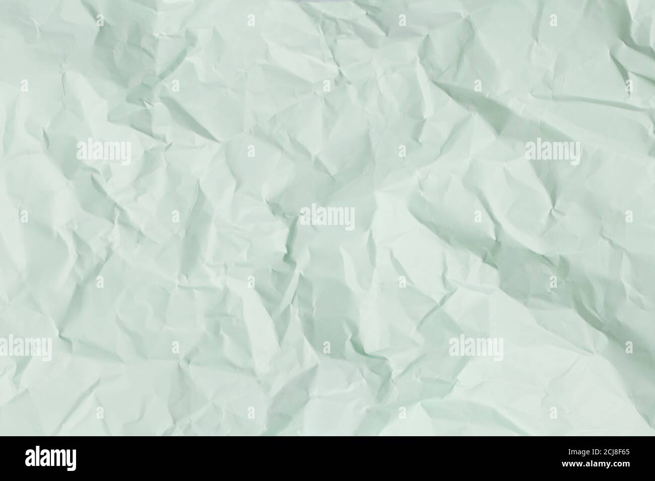 sfondo di carta crumpled verde, texture per gli screensaver di web design. Modello per vari scopi o creazione di confezioni. Foto Stock