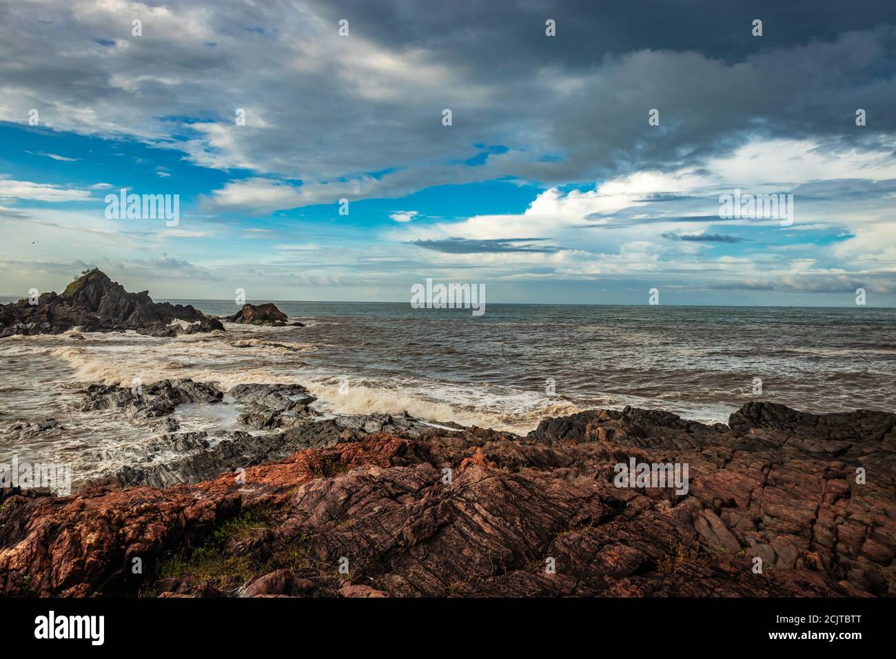 spiaggia rocciosa di mare con onde che si infrangono al mattino da un'immagine ad angolo piatto è presa alla spiaggia om gokarna karnataka india. è una delle migliori spiagge di gokarna Foto Stock