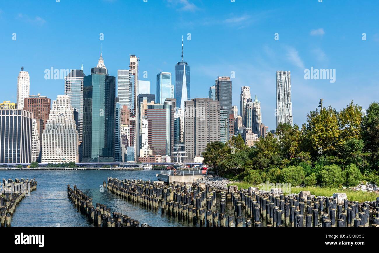 NEW YORK, NY - AGOSTO 28 2020: Lo skyline di Lower Manhattan New York, con l'East River e il Brooklyn Bridge Park in primo piano. Foto Stock