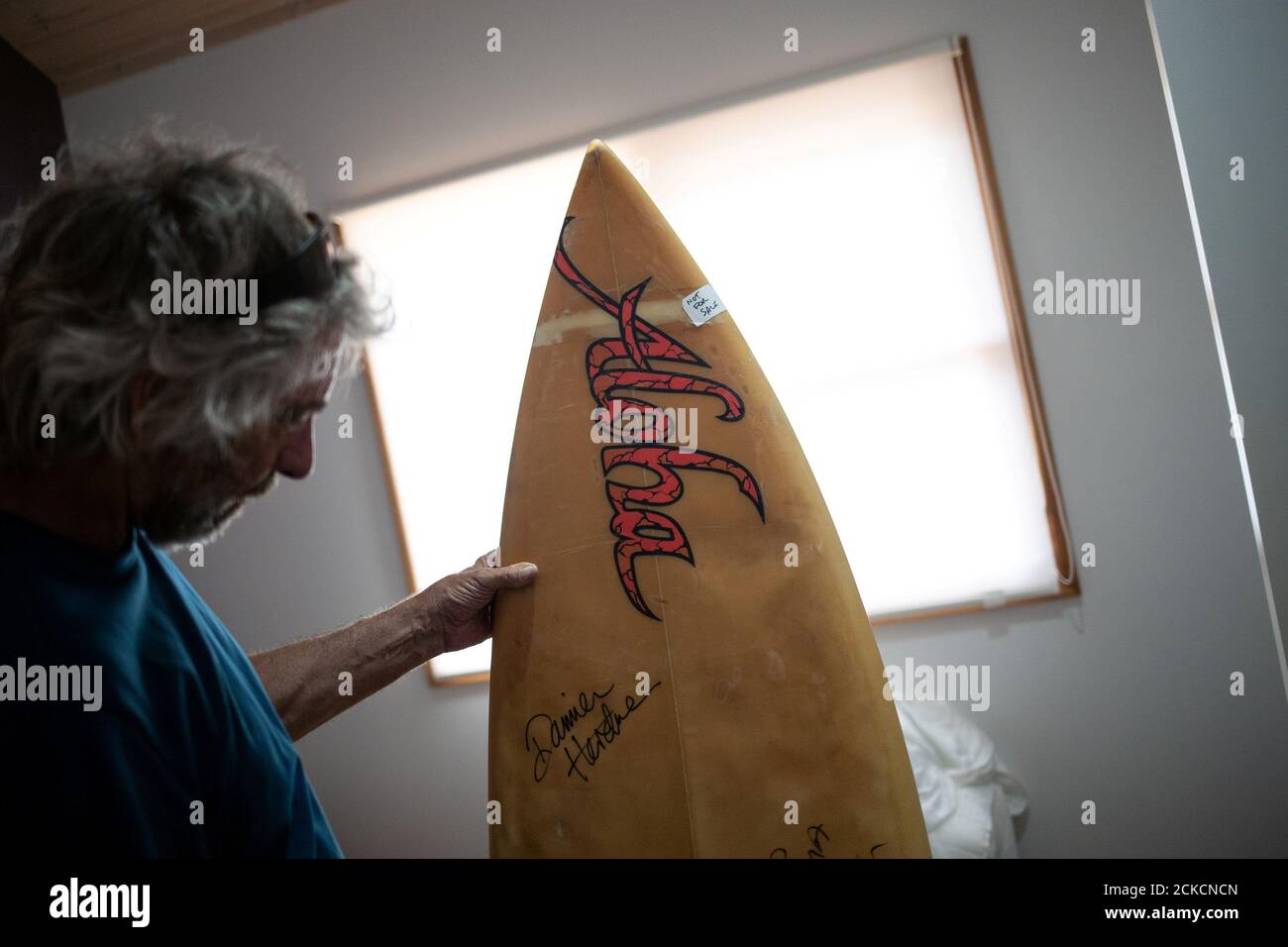 Il surfista australiano David Ford, 62 anni, mostra una delle poche tavole da surf rimaste della sua collezione vintage di tavole da surf distrutte nei recenti incendi sul lago Conjola, Australia, 15 gennaio 2020. Foto scattata il 15 gennaio 2020. REUTERS/Alkis Konstantinidis Foto Stock