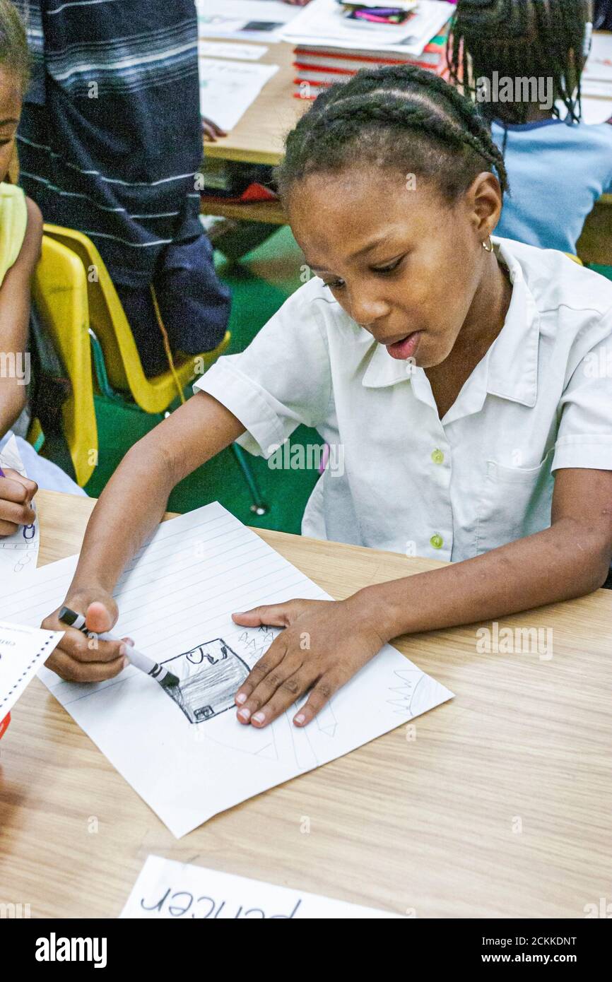 Miami Florida,Frederick Douglass Elementary School,Inside low income poverty Neighborhood minoranza africana nera studentessa ragazza scrivania disegno Foto Stock