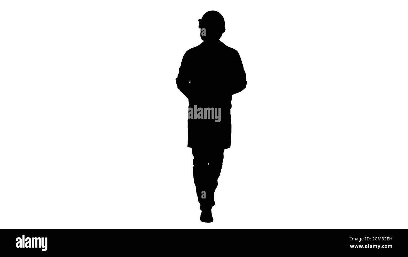 Silhouette Engineer che controlla la carta e guarda intorno ai lati. Foto Stock