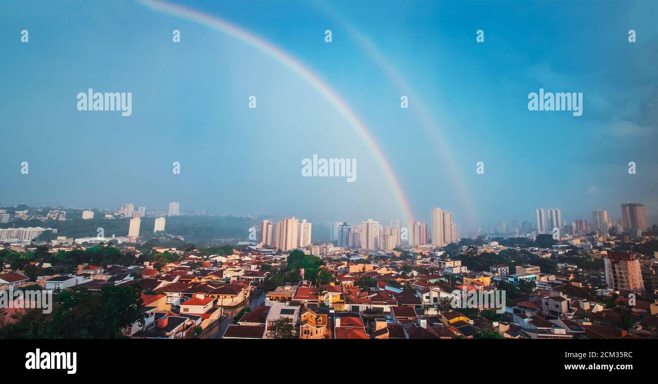 Doppio arcobaleno in un cielo blu a Ribeirao Preto immagine di concetto skyline della città. Foto Stock