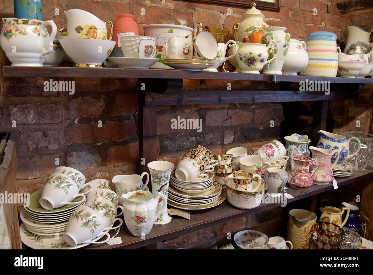 Una selezione di tazze piattini e set da tè in vendita in un centro di antiquariato a Leominster, Herefordshire Foto Stock