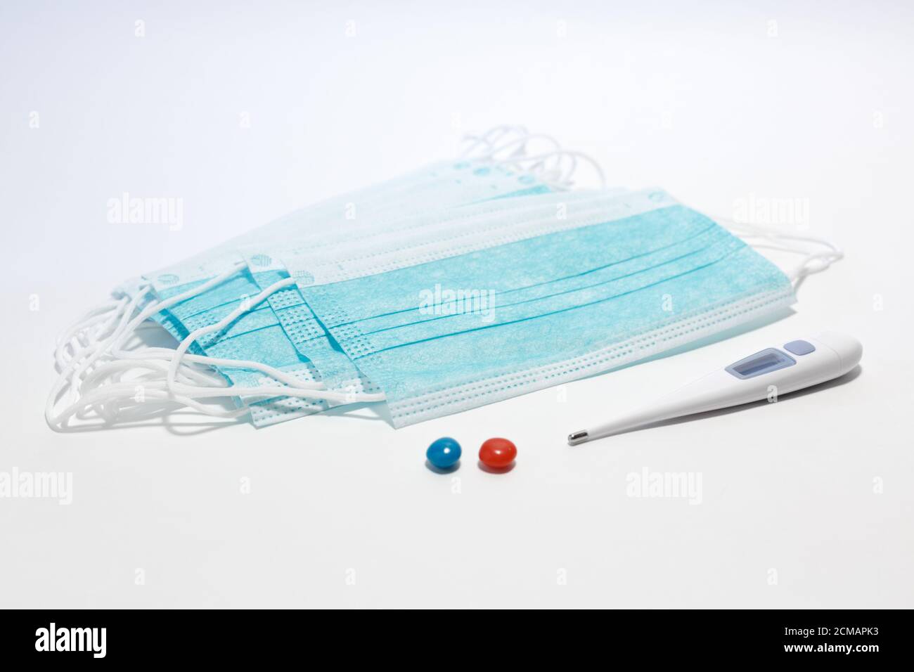 maschera medica monouso, termometro, compressa rossa, compressa blu, fuoco selettivo Foto Stock