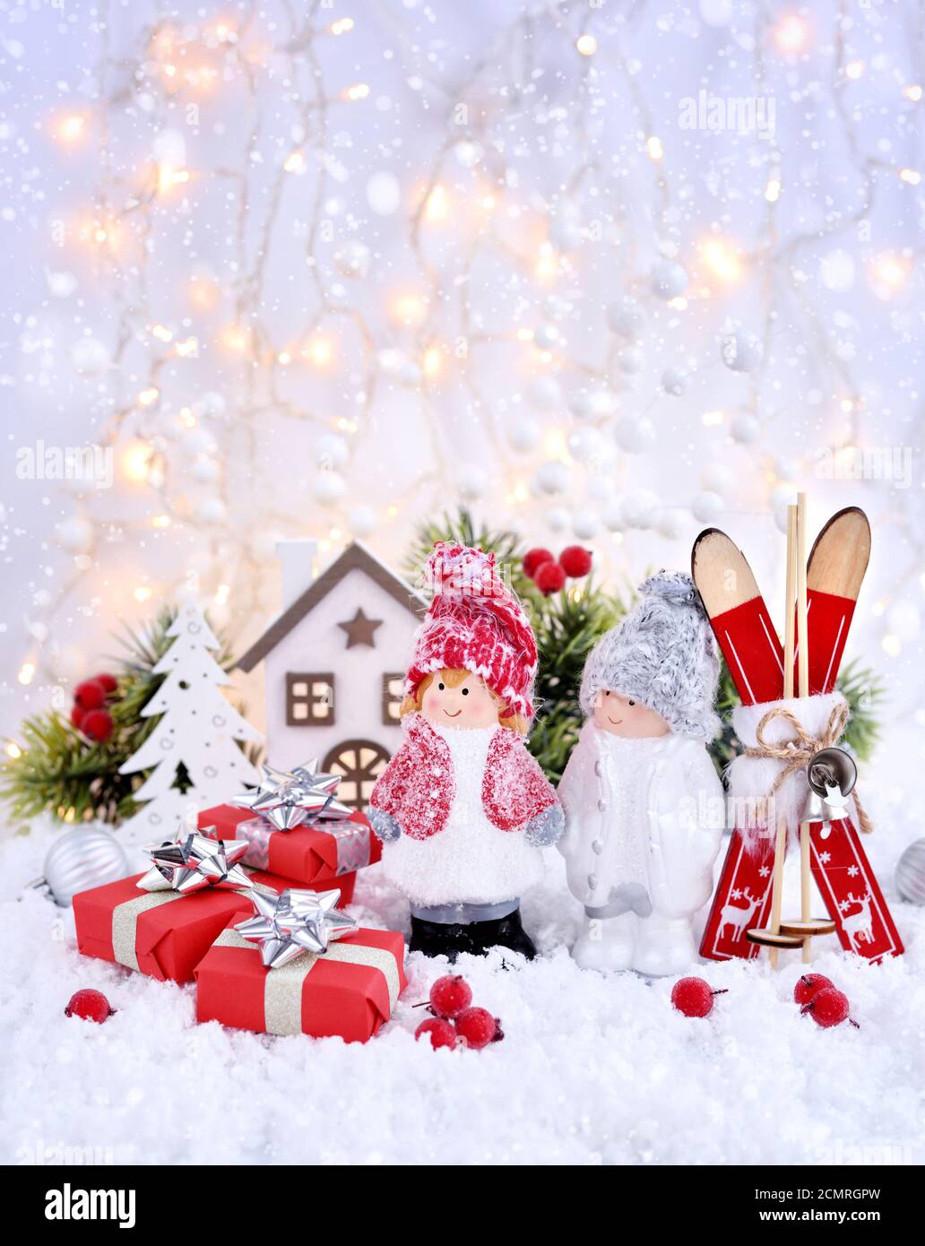 Le decorazioni di Natale poco figura un ragazzo e una ragazza con decorazioni di festa оn la neve. Natale o Capodanno saluto il card. Foto Stock