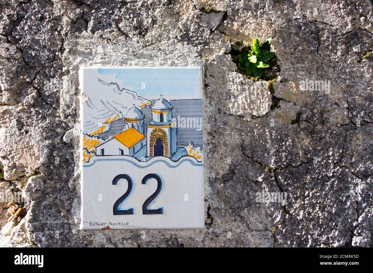 Amalfi, Italia - 5 gennaio 2015. Segno decorativo in ceramica della casa numero 22 su una vecchia parete luminosa Foto Stock