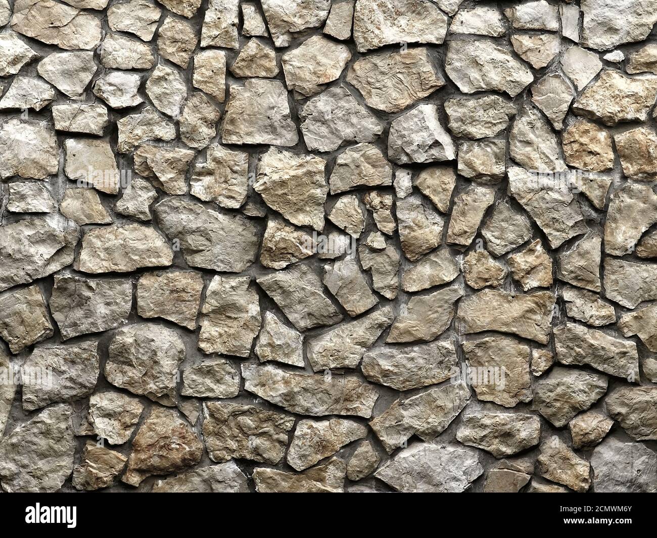 Il vecchio muro di grunge di pietre grezze come sfondo Foto Stock