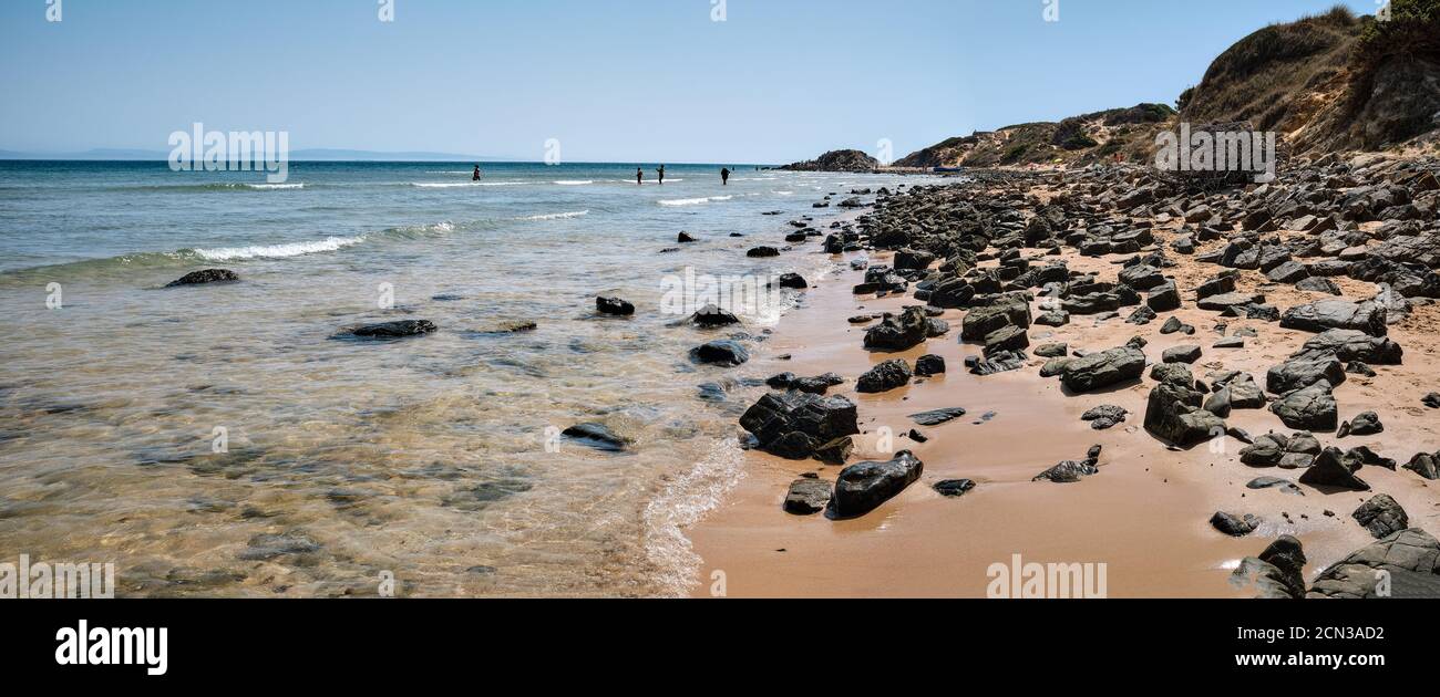 spiaggia con rocce sulla riva, acque turchesi trasparenti, sabbia fine e chiara. Punta paloma. Cádiz. Foto Stock