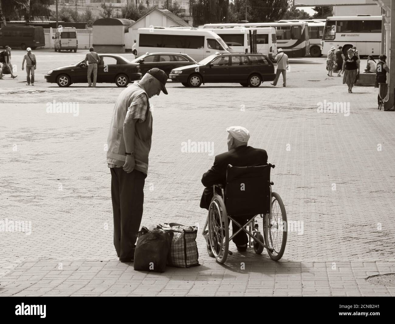 Chernihiv, Ucraina, 7 giugno 2019. Un dipendente della stazione ferroviaria comunica con un anziano in sedia a rotelle. Assistenza ai passeggeri con inabilitie Foto Stock