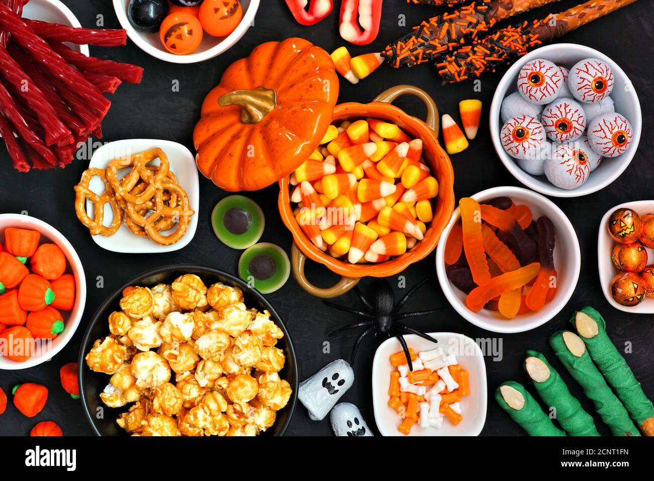 Halloween caramella scena del tavolo a buffet su uno sfondo di pietra nera. Assortimento di dolci e dolci. Vista dall'alto. Foto Stock