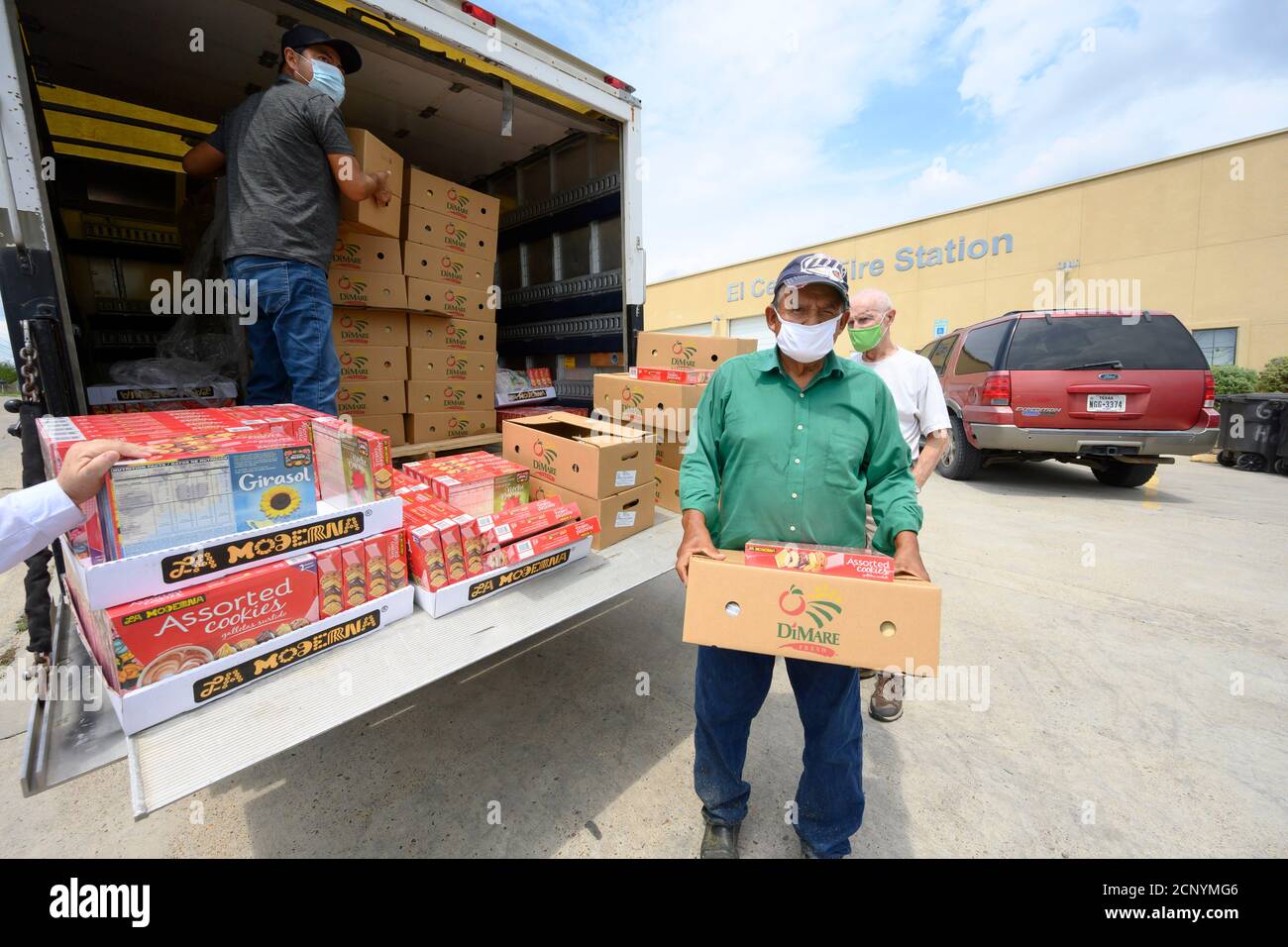 El Cenizo, Texas USA 17 settembre 2020: I volontari locali distribuiscono scatole di cibo ai residenti della colonia di El Cenizo circa 10 miglia a sud di Laredo lungo il confine tra Texas e Messico. Circa 450 famiglie vengono servite due volte alla settimana con prodotti di base e frutta fresca in uno sforzo sponsorizzato dalla Missione Luterana Latinoamericana (LALM). A causa della pandemia del coronavirus, la distribuzione è ora un evento drive-through socialmente distanziato, con volontari e clienti che indossano tutti i rivestimenti del viso. Credit: Bob Daemmrich/Alamy Live News Foto Stock