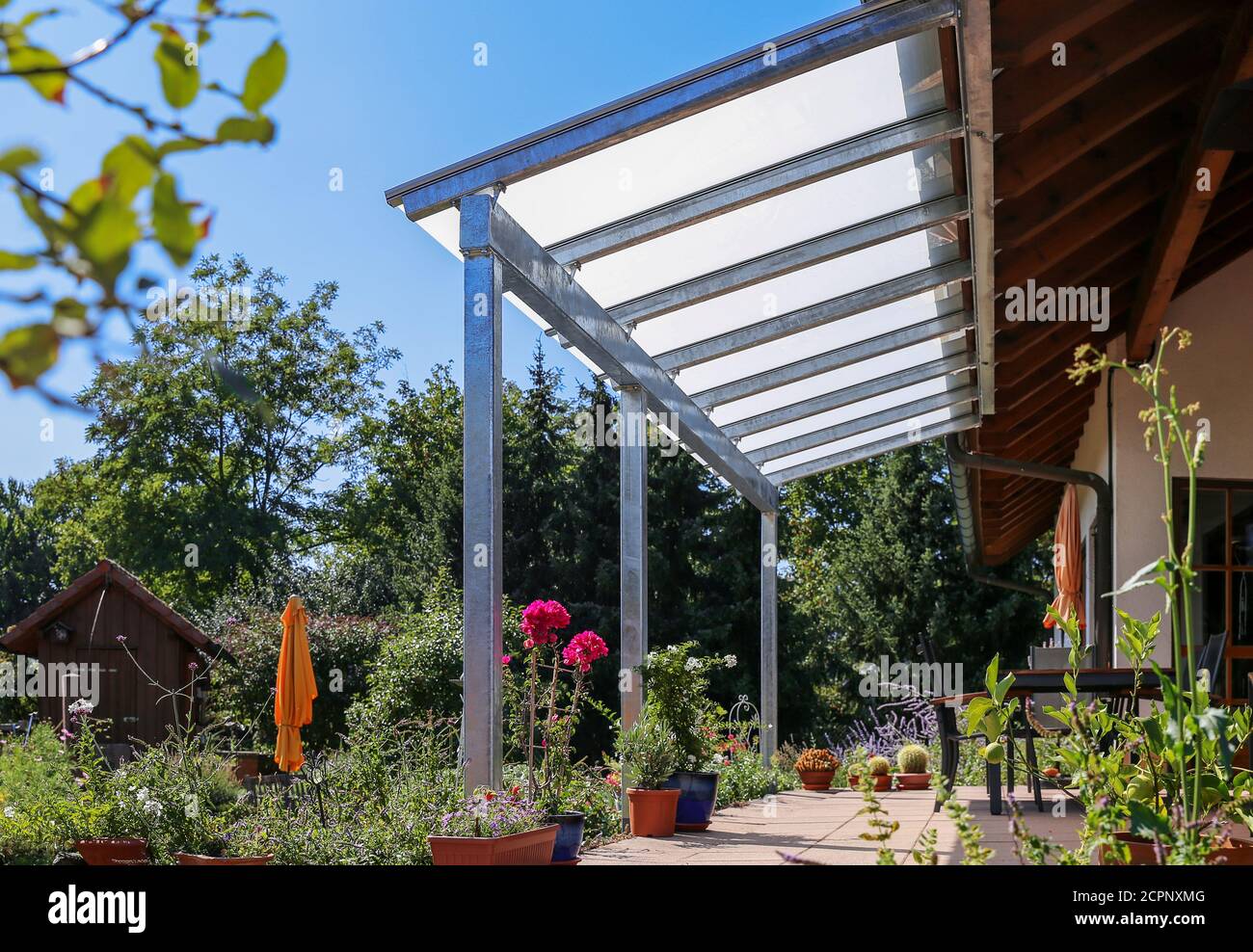 Terrazza con baldacchino in vetro e vista sul giardino Foto Stock
