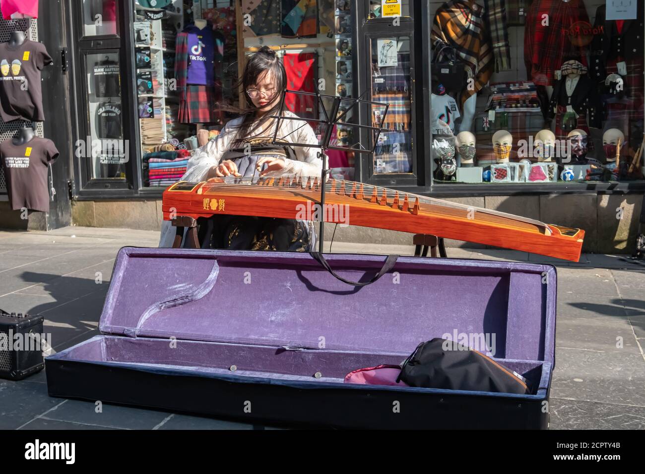 Glasgow, Scozia, Regno Unito. 19 settembre 2020. Regno Unito Meteo. Un artista di strada che si esibisce su un guzheng (Zither cinese) in via Buchanan. Credito: SKULLY/Alamy Live News Foto Stock