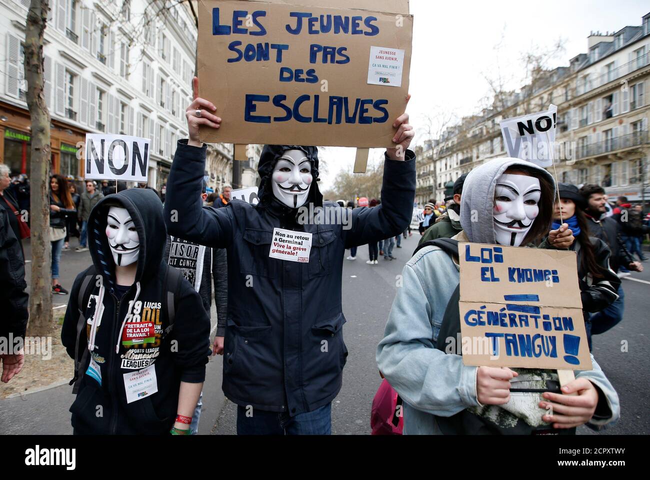 I manifestanti che indossano maschere Guy Fawkes partecipano ad una dimostrazione contro la proposta francese di legge sul lavoro a Parigi, Francia, 9 aprile 2016. Lo slogan recita 'i giovani non sono schiavi'. REUTERS/Charles Platiau Foto Stock