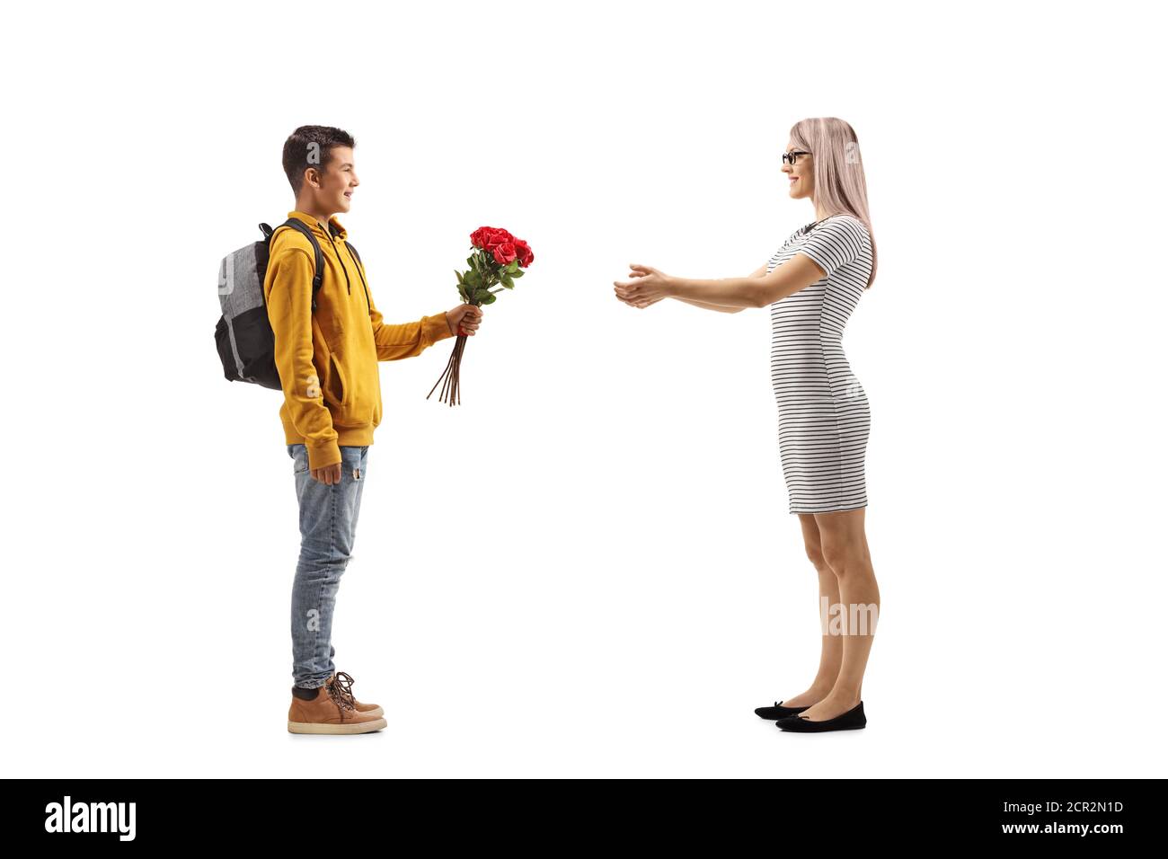 Foto di profilo di lunghezza completa di un ragazzo adolescente che dà un mazzo di rose rosse ad una donna isolata su bianco sfondo Foto Stock