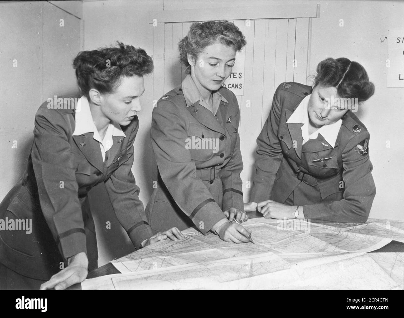 Nancy Love (1914-1976), centro, comandante dello Squadrone di ferry ausiliario delle donne (WAFS), e due studenti non identificati visualizzano le tabelle alla Scuola di distacco di addestramento volante delle donne. Dopo la laurea, le donne che hanno avuto questo tipo di addestramento di volo sono immediatamente utili come membri del comando di ferry, Sweetwater, TX, circa 1943. (Foto di Office of War Information/RBM Vintage Images) Foto Stock