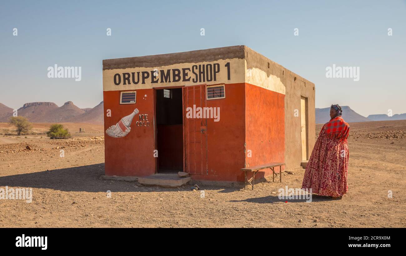 Donna in abiti tradizionali olandesi di fronte ad un negozio di alimentari nel deserto, Foto Stock