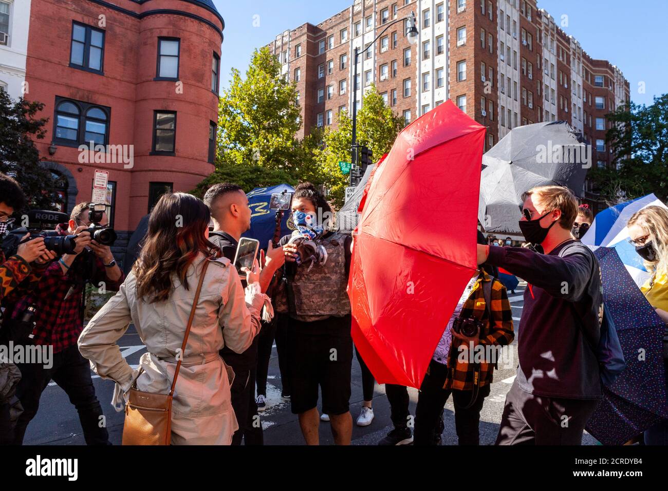 Washington, DC, USA, 19 settembre 2020. Nella foto: Una donna e un cameraman che sostengono di essere mezzi di destra sono bloccati dal filmare la protesta da manifestanti con ombrelli come due fotografi catturare la scena. Le due persone stavano cercando di filmare e manifestanti dox. La marcia per la giustizia è un evento settimanale delle proteste della DC contro la brutalità della polizia e a favore dello sfinanziamento della polizia. Credit: Alison C Bailey/Alamy Live News Foto Stock Washington, DC, USA, 19 settembre 2020. Nella foto: Una donna e un cameraman che sostengono di essere mezzi di destra sono bloccati dal filmare la protesta da manifestanti con ombrelli come due fotografi catturare la scena. Le due persone stavano cercando di filmare e manifestanti dox. La marcia per la giustizia è un evento settimanale delle proteste della DC contro la brutalità della polizia e a favore dello sfinanziamento della polizia. Credit: Alison C Bailey/Alamy Live News Foto Stock