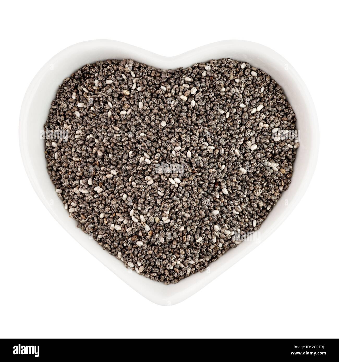 semi di chia in piastra a forma di cuore Foto Stock