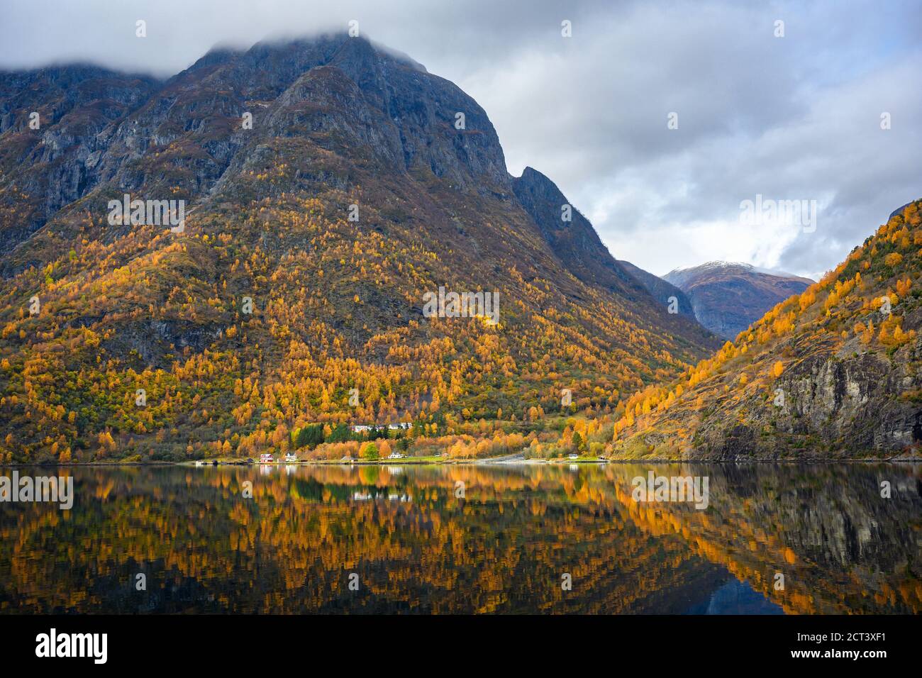 Piccolo villaggio sul lungomare e le montagne nella stagione autunnale che riflettono l'acqua. Guarda da una gita in barca per vedere la bellezza di Sognefjord Crui Foto Stock