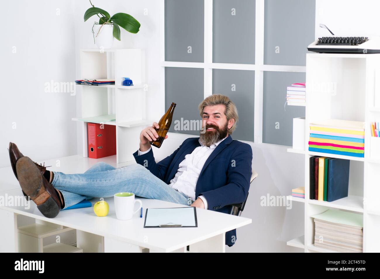 Uomo ubriaco alla fine della giornata lavorativa. Uomo manager uomo d'affari ha lavorato con successo e alla fine della giornata, bevande birra. Foto Stock