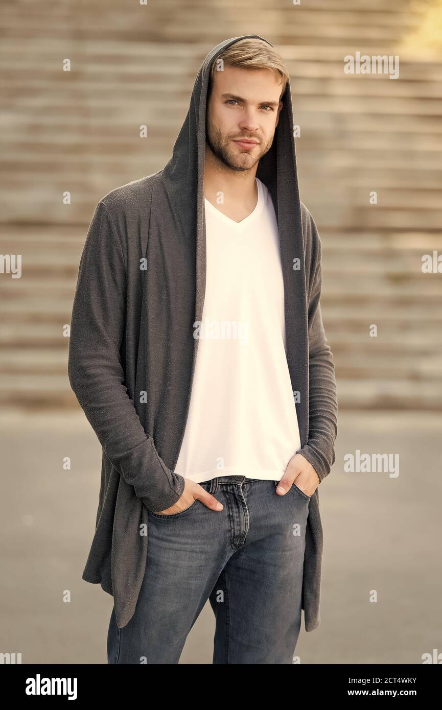 pericolosamente bello. uomo nel cappuccio. hooligan indossa la felpa con  cappuccio. come ladro nel cardigan con cappuccio. Stile casual. Concetto di  pericolo e fiducia. Look di moda urbano. Vita moderna della città.