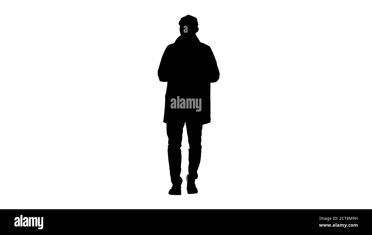 Silhouette uomo giovane che indossa un trench che parla con la fotocamera. Foto Stock