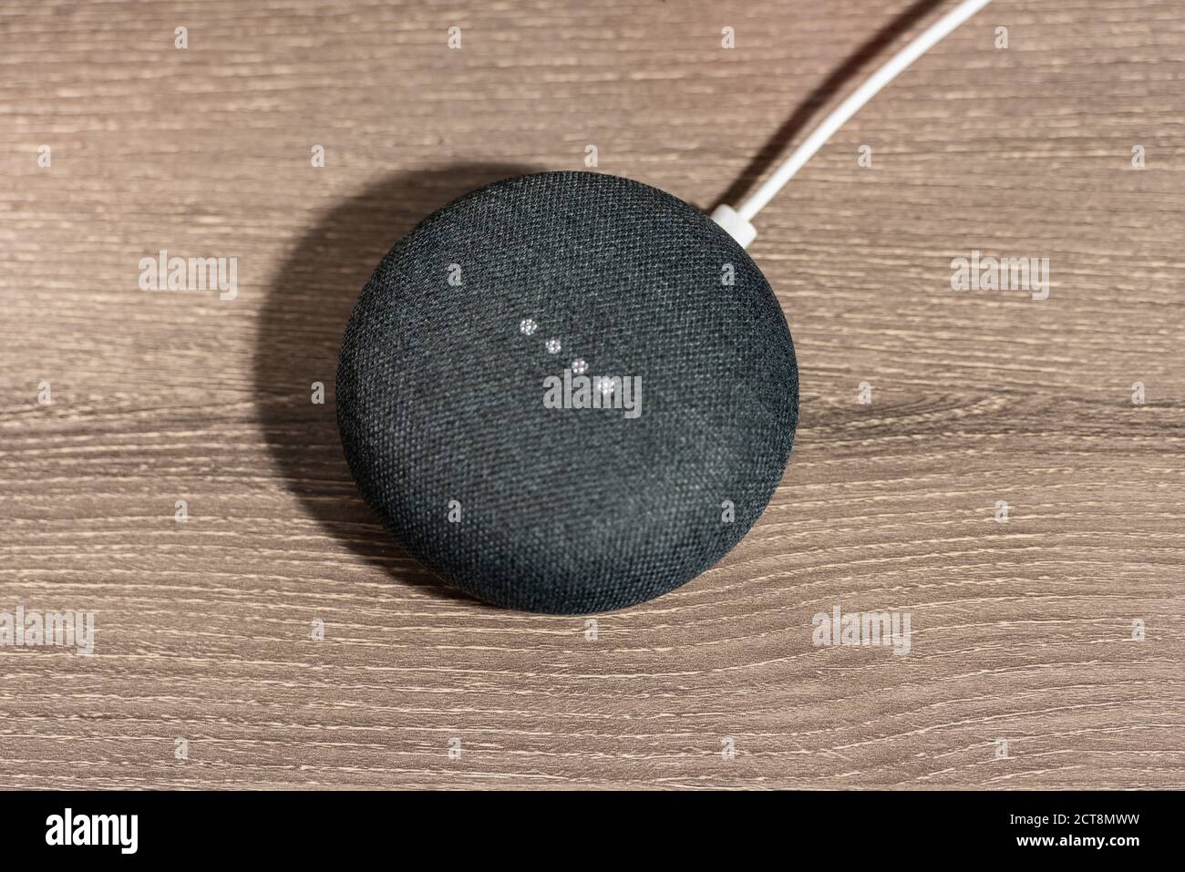 Mini altoparlante grigio Google Home Smart sulla scrivania dell'ufficio Foto Stock