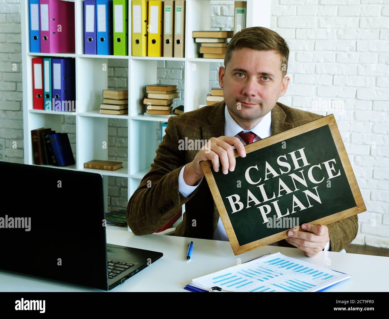 Piano di saldo in contanti. Un uomo ha un segno con l'iscrizione. Foto Stock