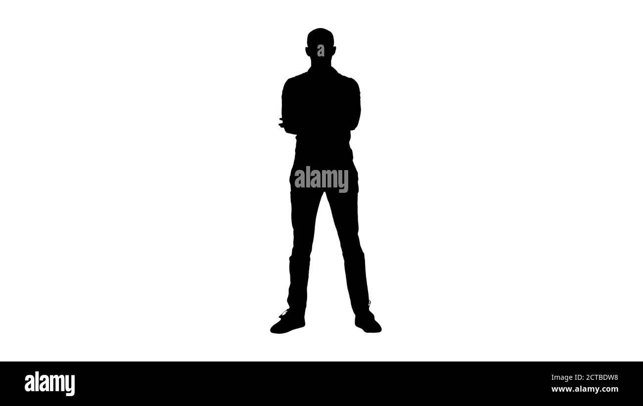 Silhouette uomo arabo sicuro e casual piega le mani guardando nella fotocamera. Foto Stock