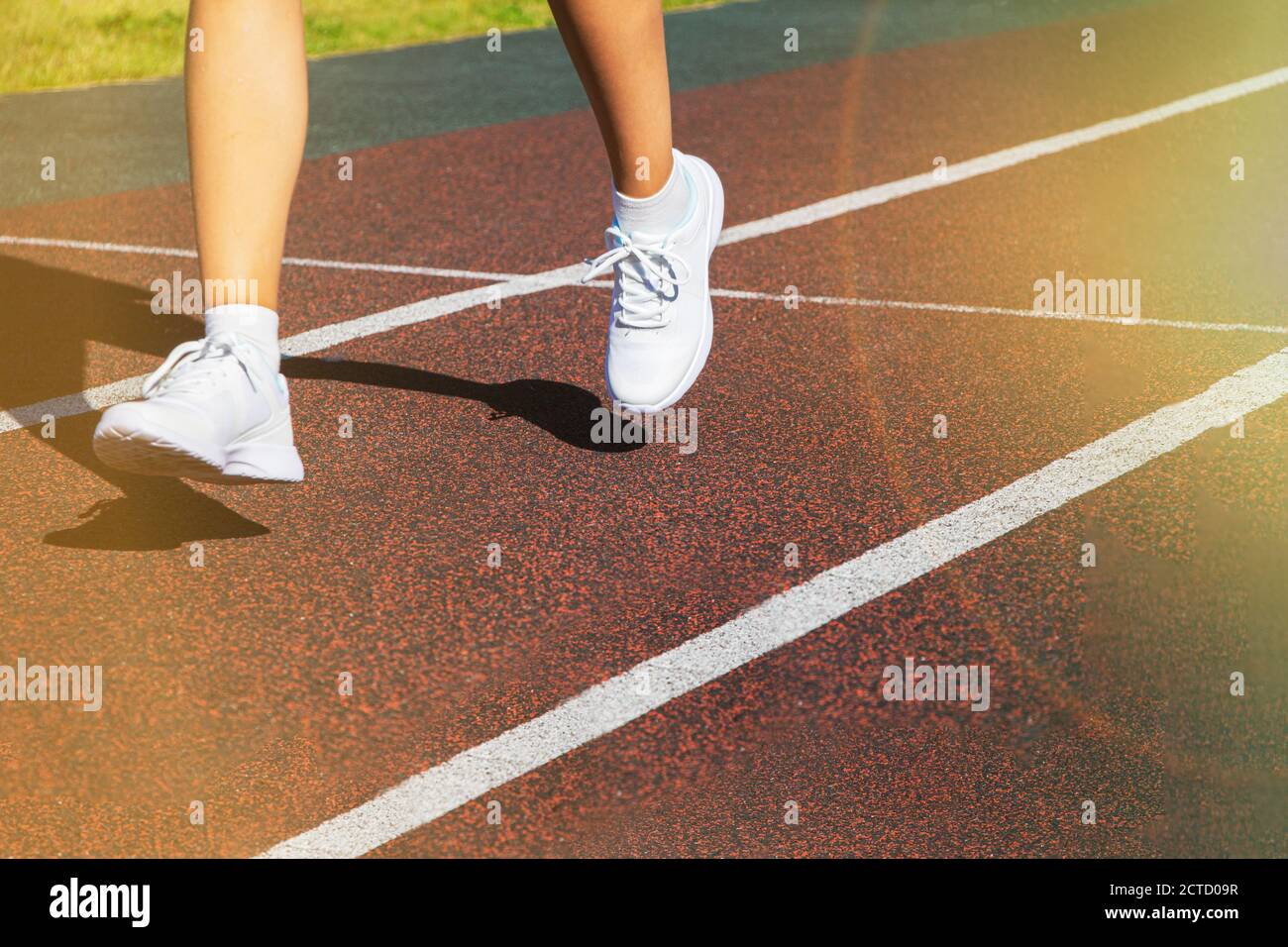 I piedi di un corridore corrono lungo la strada in primo piano sulle loro scarpe. Allenamento in corsa, stile di vita sano. Foto Stock