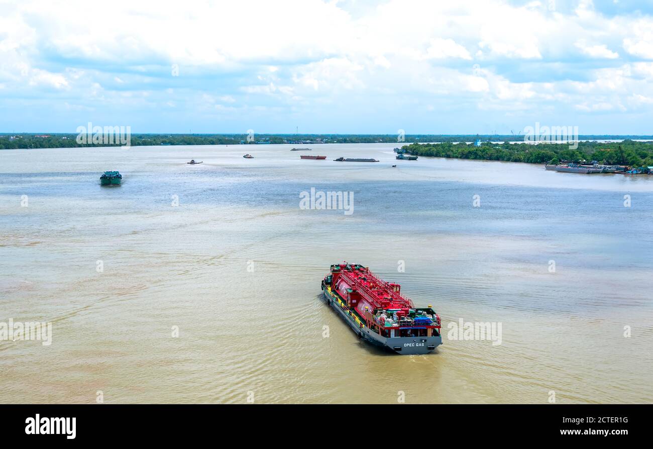 Le navi che trasportano gas sul fiume Mekong inferiore sono ricche di alluvione nelle mattine d'estate, aiutando lo sviluppo economico a Tien Giang, in Vietnam Foto Stock