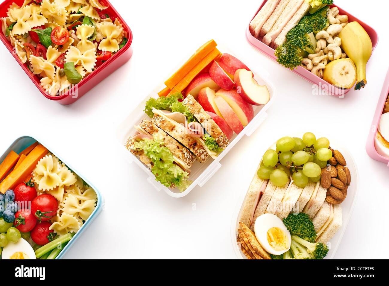 Vista dall'alto dei pranzi a scuola con vari pasti nutrienti sani su sfondo bianco. Pranzo da sopra Foto Stock