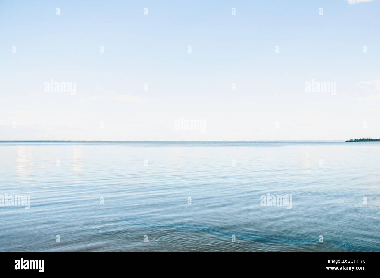 Mare con acqua calma e cielo limpido in estate sera al tramonto Foto Stock