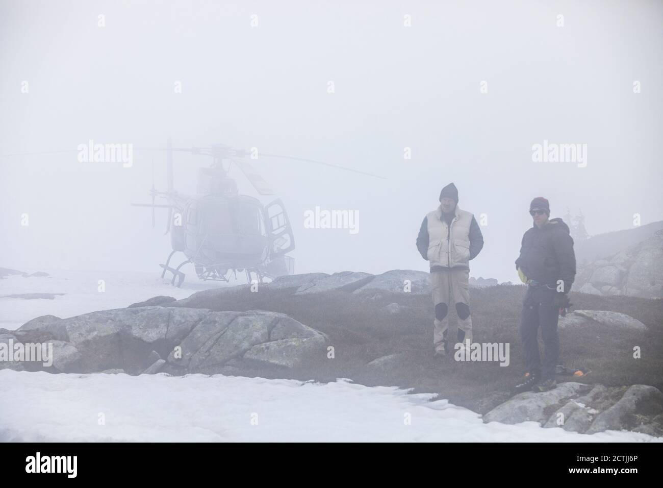 Il pilota dell'elicottero e il passeggero aspettano il maltempo, scarsa visibilità. Foto Stock