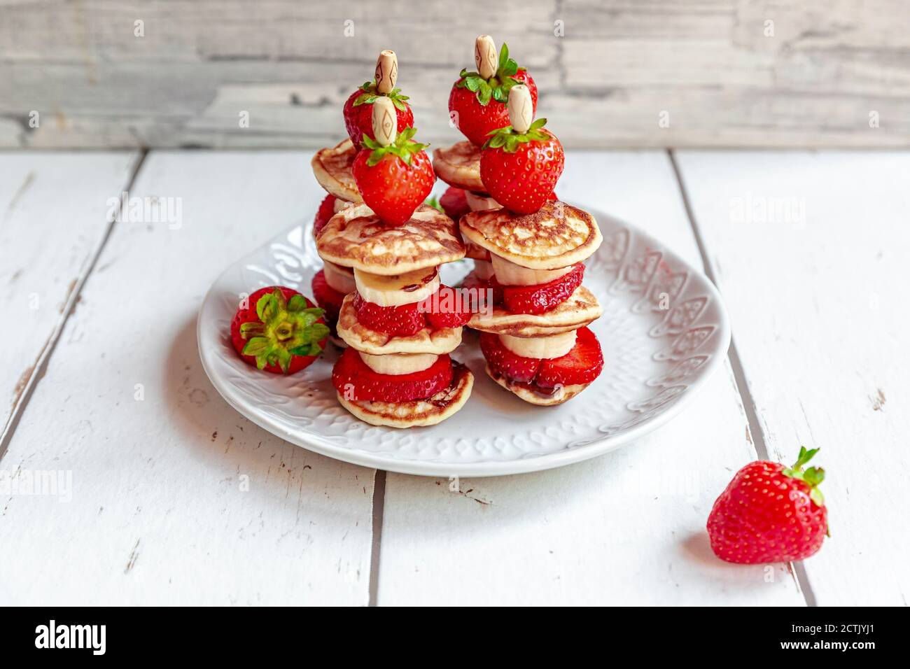 Piatto di mini frittelle con fragole e banane Foto Stock