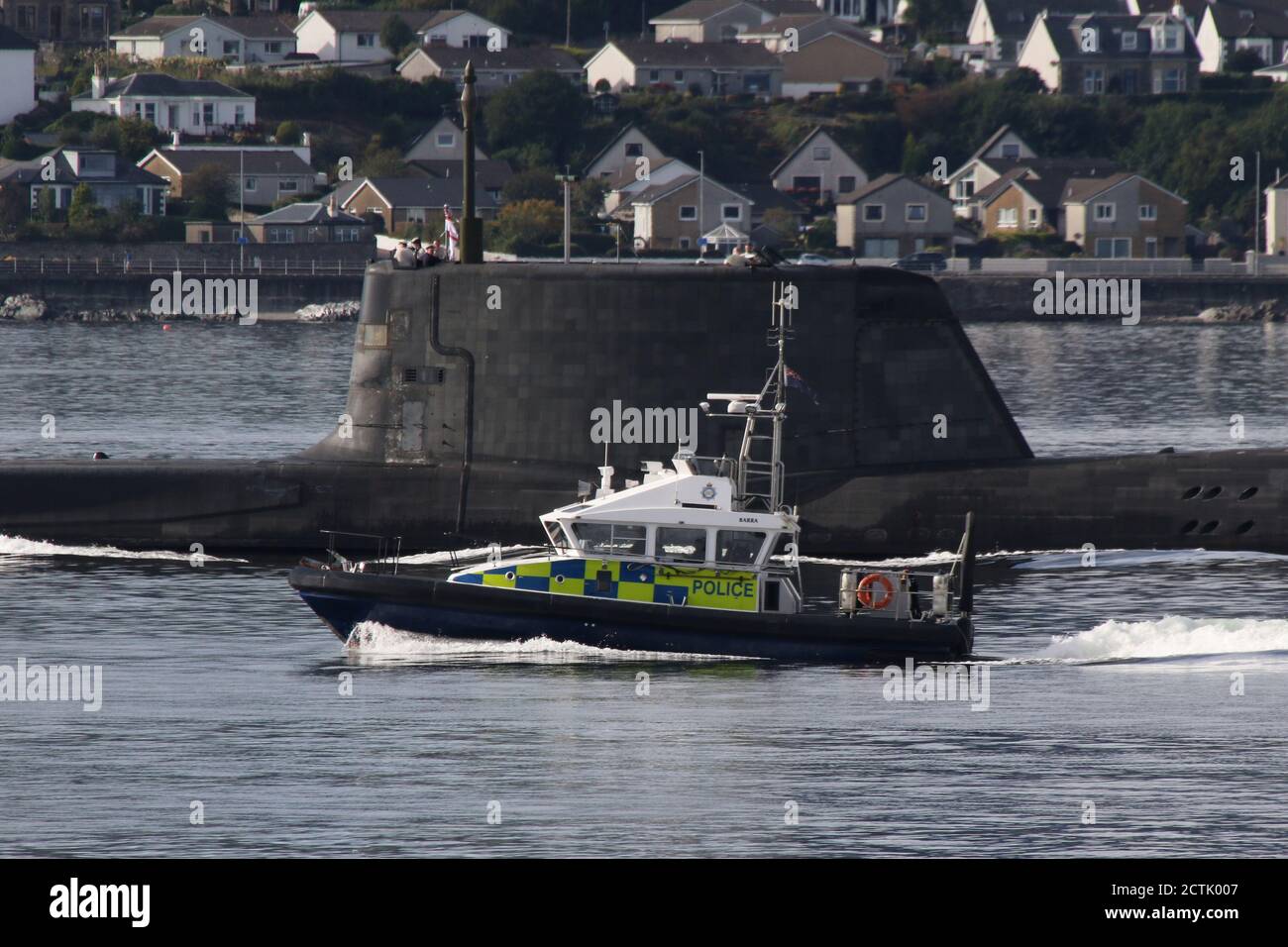 Un sottomarino di classe astuta gestito dalla Royal Navy, che si dirige verso il Firth of Clyde poco dopo la partenza dalla sua base di Faslane, con una scorta del Ministero della Difesa a forma di nave di classe insulare MDP barra. Foto Stock