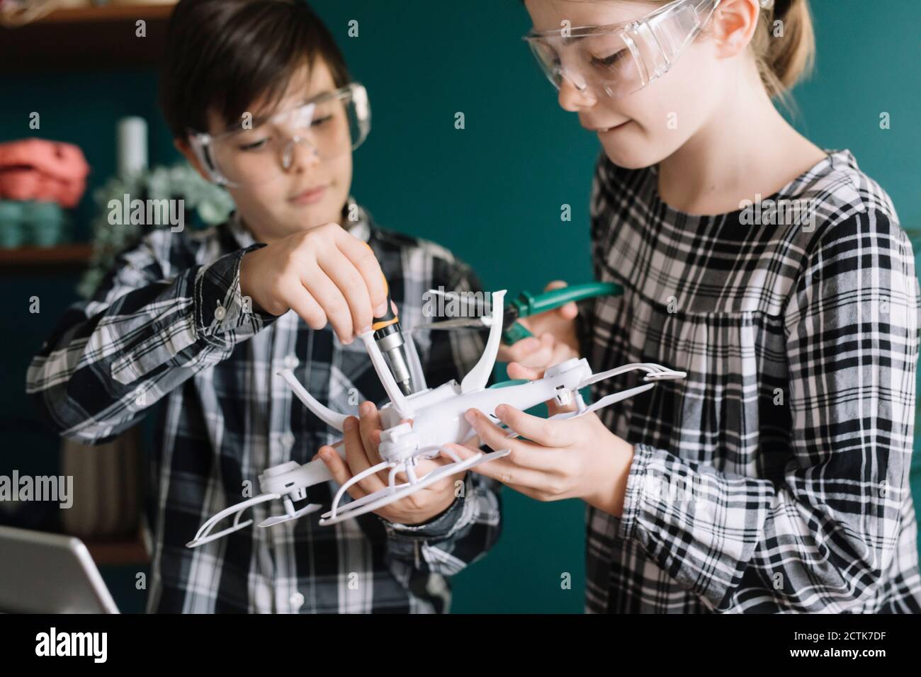 Primo piano di fratelli che fanno il drone a casa Foto Stock
