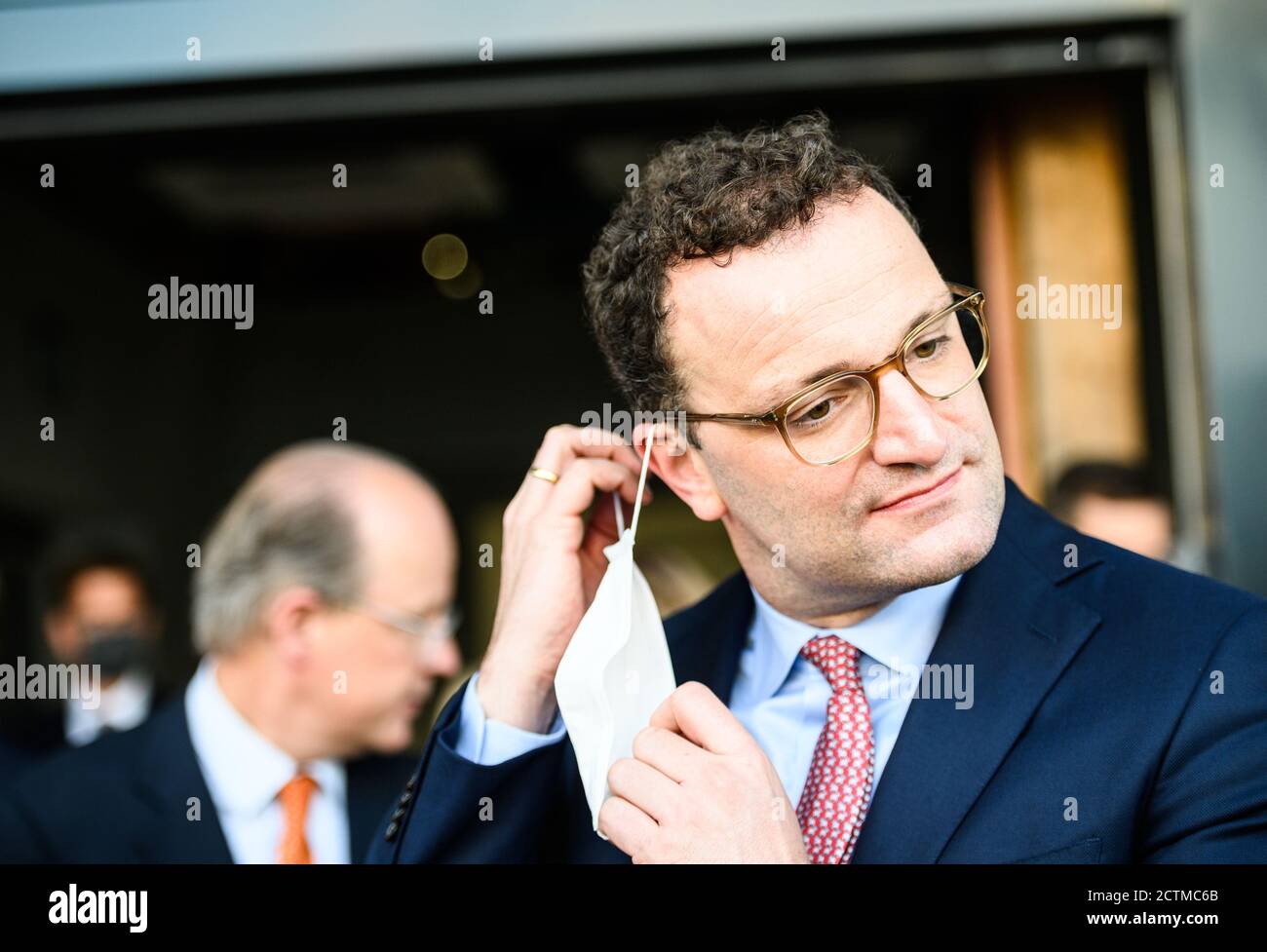 22 settembre 2020, Renania-Palatinato, Ingelheim am Rhein: Jens Spahn (CDU), Ministro federale della sanità, toglie la sua maschera durante la sua visita alla società farmaceutica Boehringer Ingelheim. Foto: Andreas Arnold/dpa Foto Stock