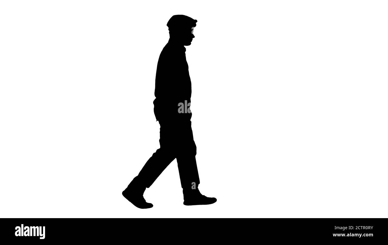 Silhouette elegante ragazzo adolescente in una camicia e un cappellino che cammina. Foto Stock