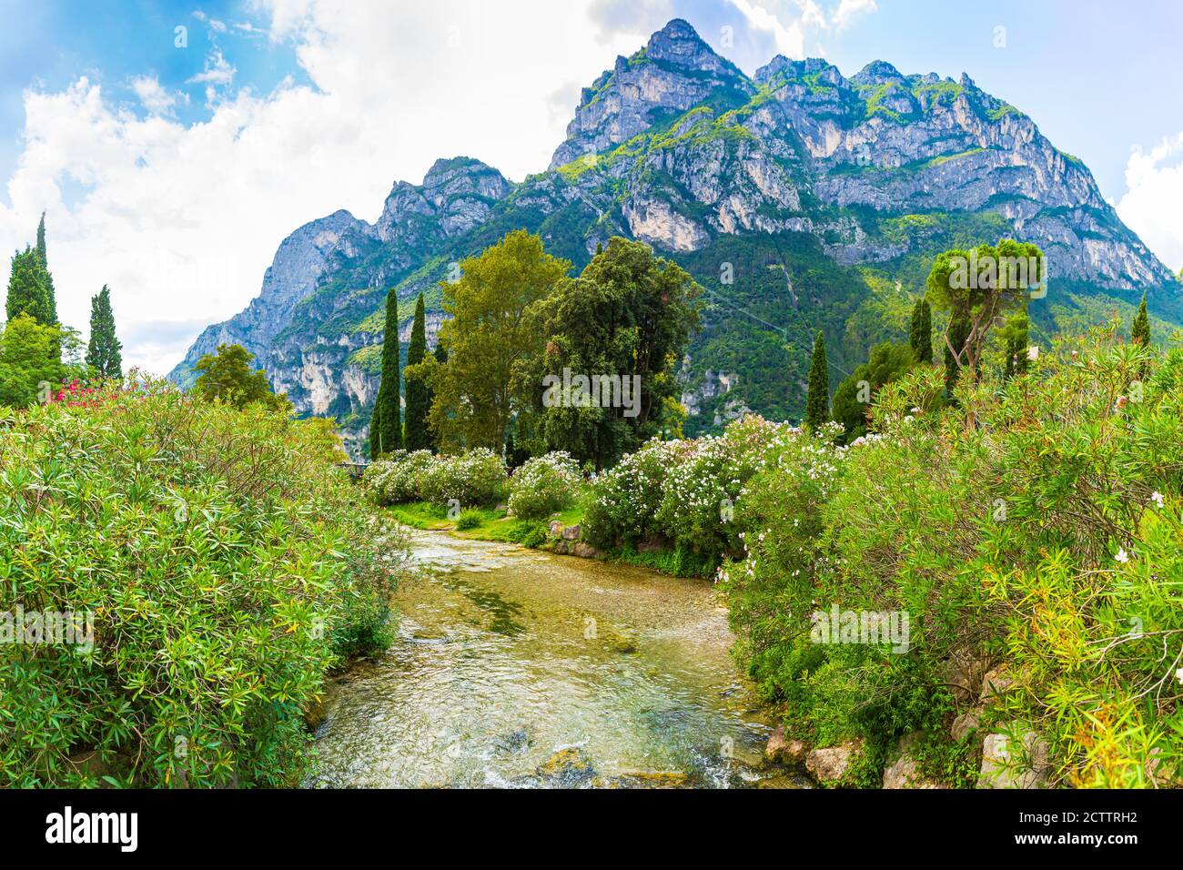 Splendido paesaggio estivo con acqua, montagne e vegetazione verde vicino al lago di Garda Riva del Garda Foto Stock