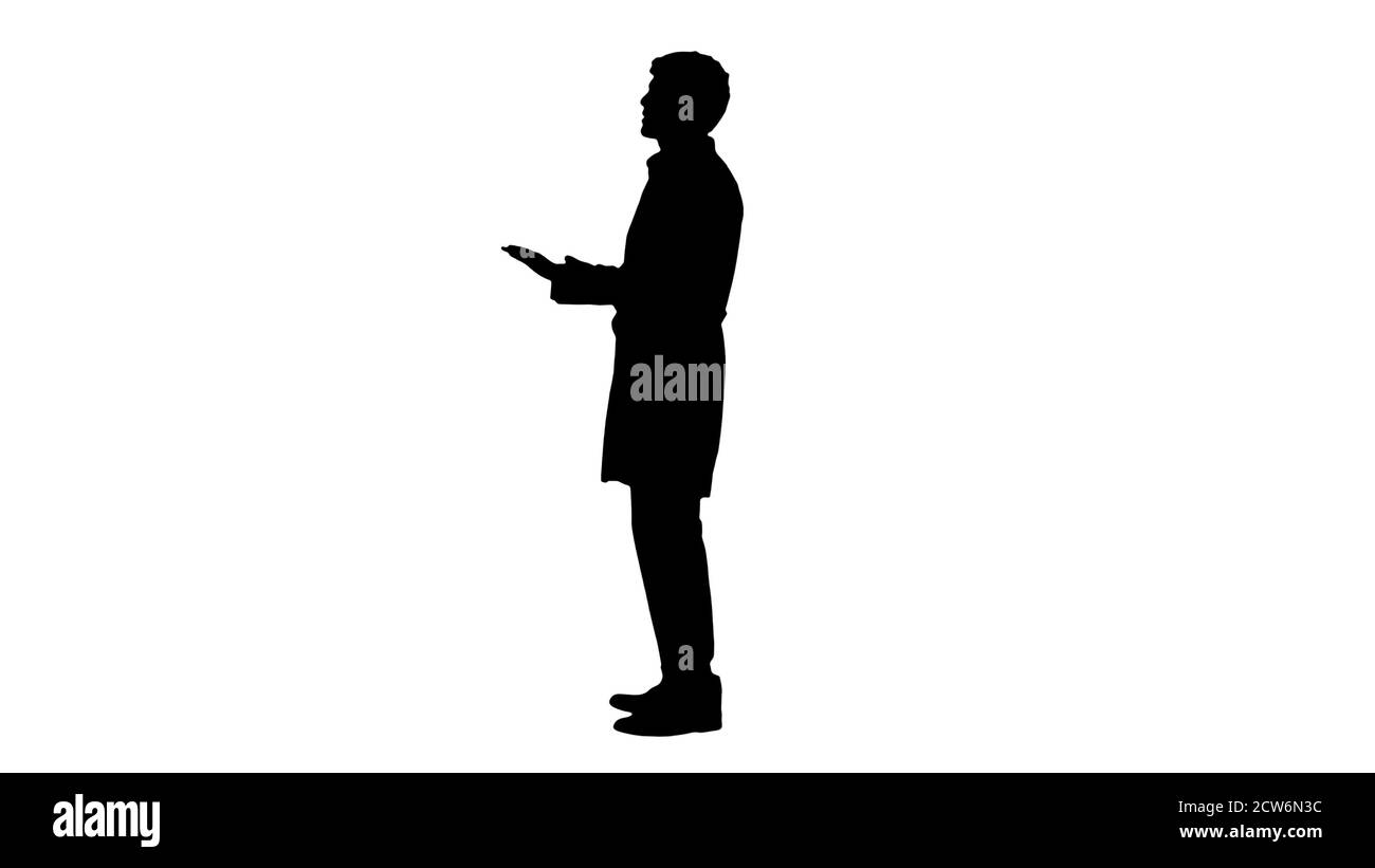 Silhouette Doctor indossando un cappotto bianco che spiega qualcosa. Foto Stock