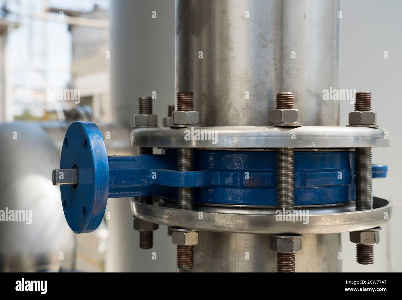 Zona industriale. Apparecchiature industriali, tubi e tecnologia moderna. Oggetti metallici in una fabbrica. Vista ravvicinata di viti e tubi della linea tecnologica Foto Stock