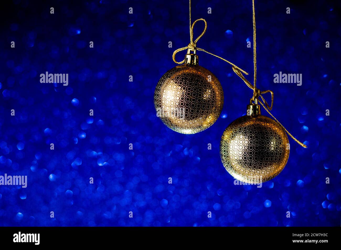 Palle dorate dell'albero di Natale su glitter e brillare sfondo blu classico. Vacanze invernali stile retrò composizione. Decorazione di Natale e Capodanno. Foto Stock